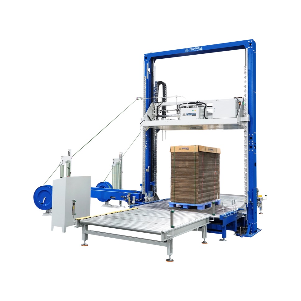 Vertical Strapping Machine With <em style="color: #0035A7;">Dual Heads</em>, <em style="color: #B80096;">Compression</em> and <em style="color: #710A0C;">Cross Lifting Rotary Table</em>